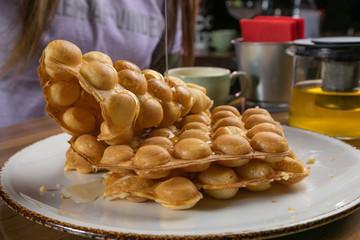  Waffles with honey on a wooden table