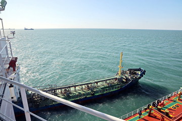 Bunkering of a ship on the open roadstead of the port of Dalian, China. January,2020.