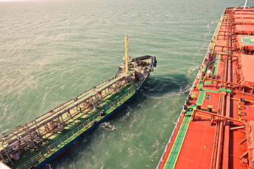Bunkering of a ship on the open roadstead of the port of Dalian, China. January,2020.