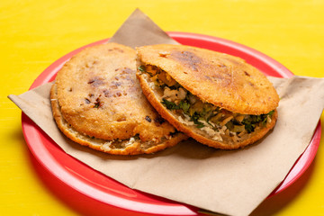 Mexican fried gorditas on yellow background