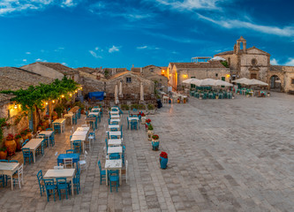 Aerial view of the colorful outdoor cafe and coastal sicilian village Marzamemi in province of Syracuse in Sicily, south Italy