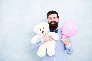 tuxedo man ready for romantic date. valentines day gift. happy birthday. go for present shopping. brutal bearded hipster in formal wear. businessman hold bear toy and balloon. copy space