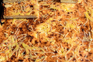 Small vanilla and cheese home made pies in display at a street food market, in soft focus