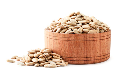 Sunflower seeds peeled in a wooden plate close-up. Isolated on a white