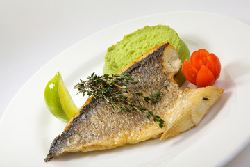 Appetizing grilled dorado fish with vegetables isolated on white background