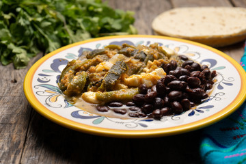 Mexican poblano pepper rajas and panela cheese on wooden background