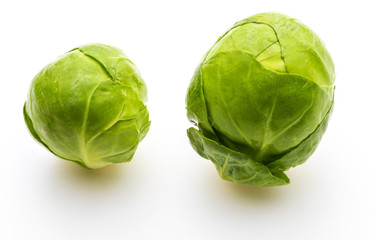 Close-up of raw, fresh and whole brussels sprouts (cabbages - Brassica oleracea). Isolated on white background.