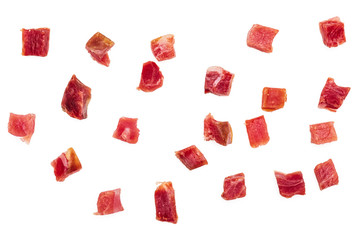Iberian ham (serrano) cut into cubes (diced). Isolated on white background.