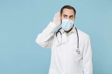 Male doctor man in white medical gown sterile face mask gloves isolated on blue background....