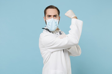Side view of male doctor man in medical gown sterile face mask gloves isolated on blue background....