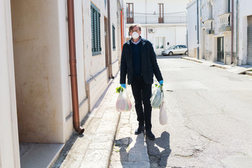 Man back from shopping wearing masks to contain the spread of Coronavirus.