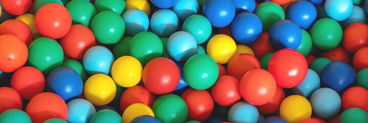 plastic balls of red yellow blue and green colors put in heap on children playground