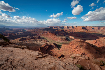 Fototapeta na wymiar Clouds billow as the Colorado River flows around the bend of Dead Horse Point in Utah