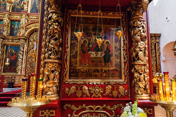 Fototapeta na wymiar Orthodox Church. Christianity. Festive interior decoration with burning candles and icon in traditional Orthodox Church on Easter Eve or Christmas. Religion faith pray symbol.