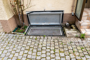 Basement window with insect screen embedded in the floor