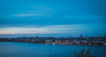 Fototapeta na wymiar Beautiful landscape photo of Stockholm cityscape viewed from Skinnarviksberget on early evening in autumn. Beautiful Stockholm evening panorama from famous vantage point.