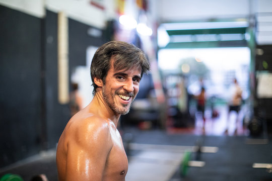 Cheerful athlete standing in gym