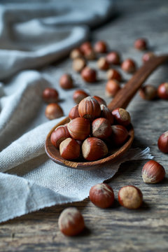 Brown ripe hazelnut on spoon at table