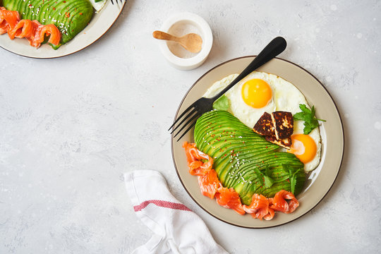 Healthy breakfast with fried eggs and avocado