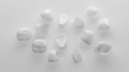 beautiful photo of dental crowns and veneers on a white background in black and white style