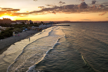 Aerial view of Pomorie city that is located on Black Sea shore. Top view of sand beaches with many hotel buildings and tourist infrastructure.