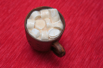 Marshmallows with cocoa in a brown clay cup