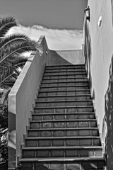 staircase that leads upstairs to the outside of a small colonial building