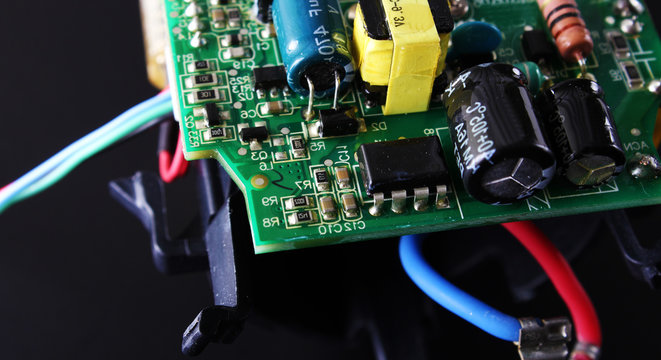 electronic circuit components on a black background