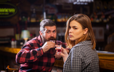 Young woman has problems with alcohol. Female male alcoholism. Woman and man alcoholism. Young man drinking alcohol. Woman alcoholic beverage in bar