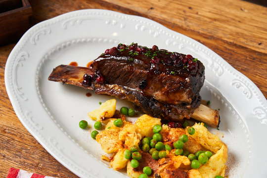 Delicious meat with berry sauce and potatoes