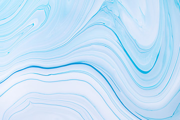 Fluid art texture. Abstract backdrop with swirling paint effect. Liquid acrylic picture with flows and splashes. Mixed paints for posters or wallpapers. Blue, white and mint overflowing colors