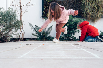children playing hopscotch in a terrace outdoors