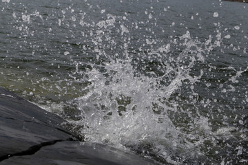 Waves hitting rocks in Helsinki, Finland. Beautiful photo representing the power and strength of the sea during windy weather. Waves can be dangerous but they also create beautiful splashes.