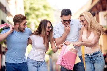 Group of young friends shopping outdoors together