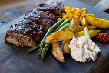 Barbeque ribs, chips, coleslaw and grilled asparagus