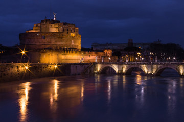 Fototapeta na wymiar Long exposure in Sant Angelo Castle, Sant Angelo bridge and river Tiber at night with light set, Rome, Italy. Top view.