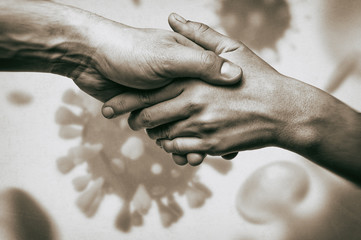 Image of humans handshake on coronavirus background. Concept of rescue from global pandemic.