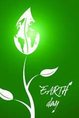 Sprout with leaf in a shape of Earth on a green nature background. Earth day. Ecology concept.