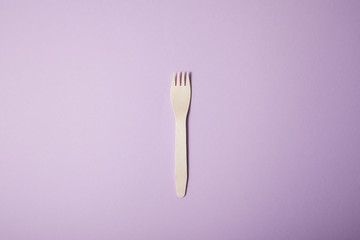 fork isolated on violet background