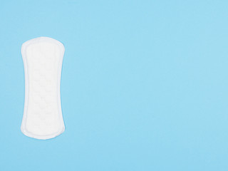 Women's sanitary napkin on blue background.