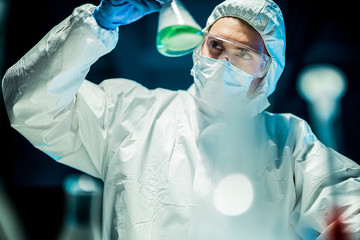 corona virus concept. male doctor reviewing glass flask