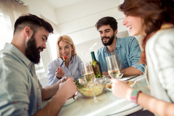 Friends having lunch together at home.