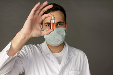 A medical worker holds a vaccine against a deadly virus