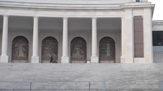 Mother pushing her baby cart at the Sanctuary of Fatima, which is also referred to as the Basilica of Lady Fatima, Portugal