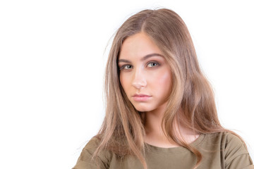 Naklejka premium Pretty young girl with long brunette hair looks at camera over white background