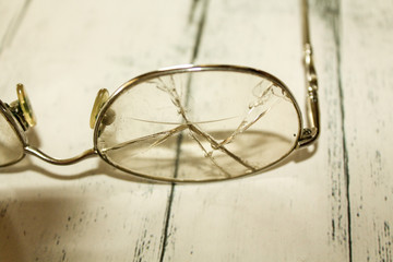 Broken glasses closeup on table