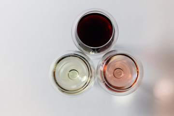 Top view on wine glasses with white, pink, red vine 