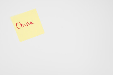 China in bold red lettering on a yellow sticky note with copyspace