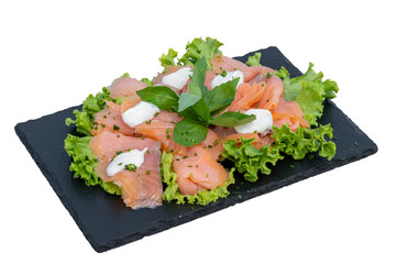 Marinated salmon fillet on a bed of lettuce, mozzarella, basil and olive oil.