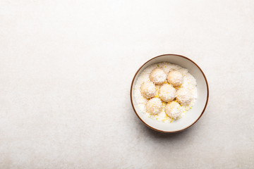 Homemade Raw Vegan Coconut and Lemon Truffles on White Background